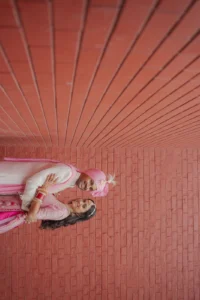 Artistic Couple Portrait Against Terracotta Backdrop