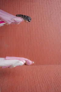 Artistic Wedding Couple Portrait Against Terracotta Wall