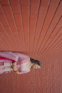 Bride and Groom Portrait Against Terracotta Wall