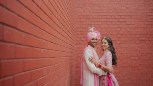 Bride and Groom Portrait Against Terracotta Wall