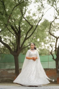Bride in White Lehenga Beneath Garden Trees