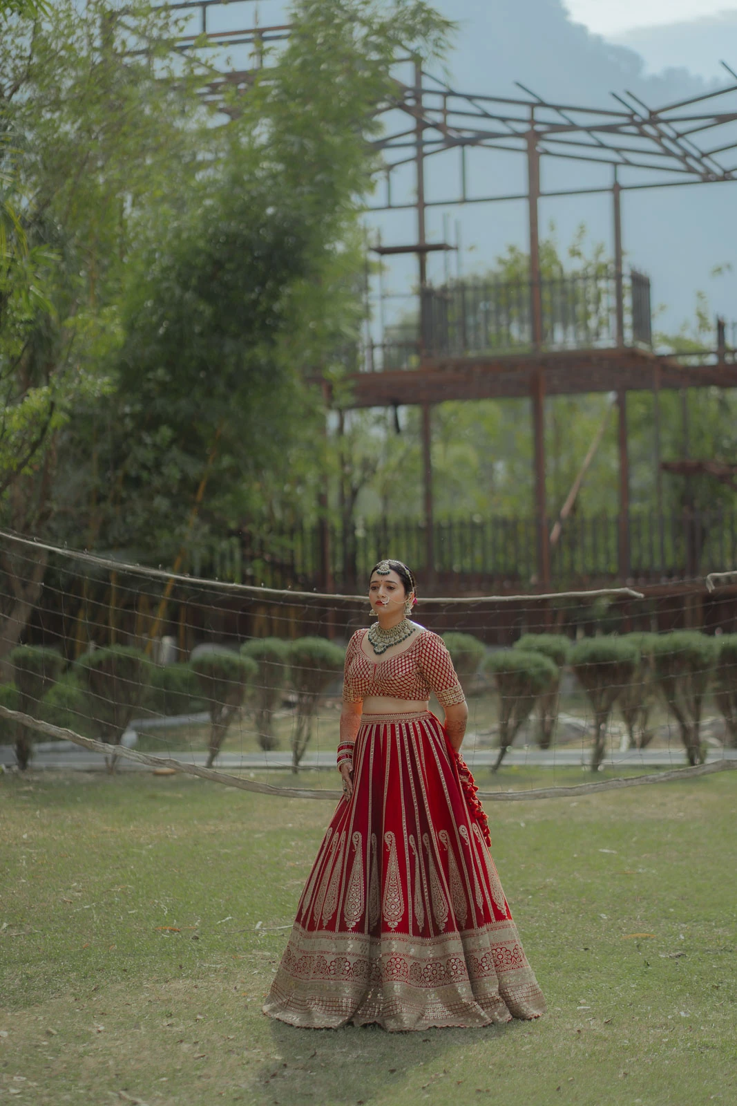 Elegant Bride in Red Lehenga at Outdoor Wedding Venue