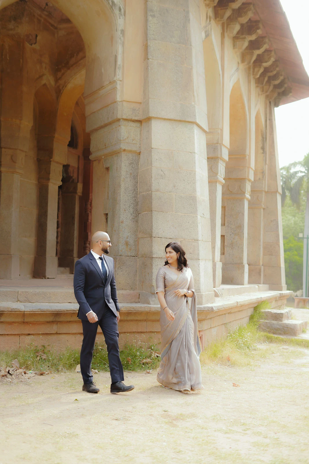 Elegant Couple Walking Through a Delhi Heritage Archway