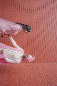Intimate Wedding Couple Portrait Against Pink Wall