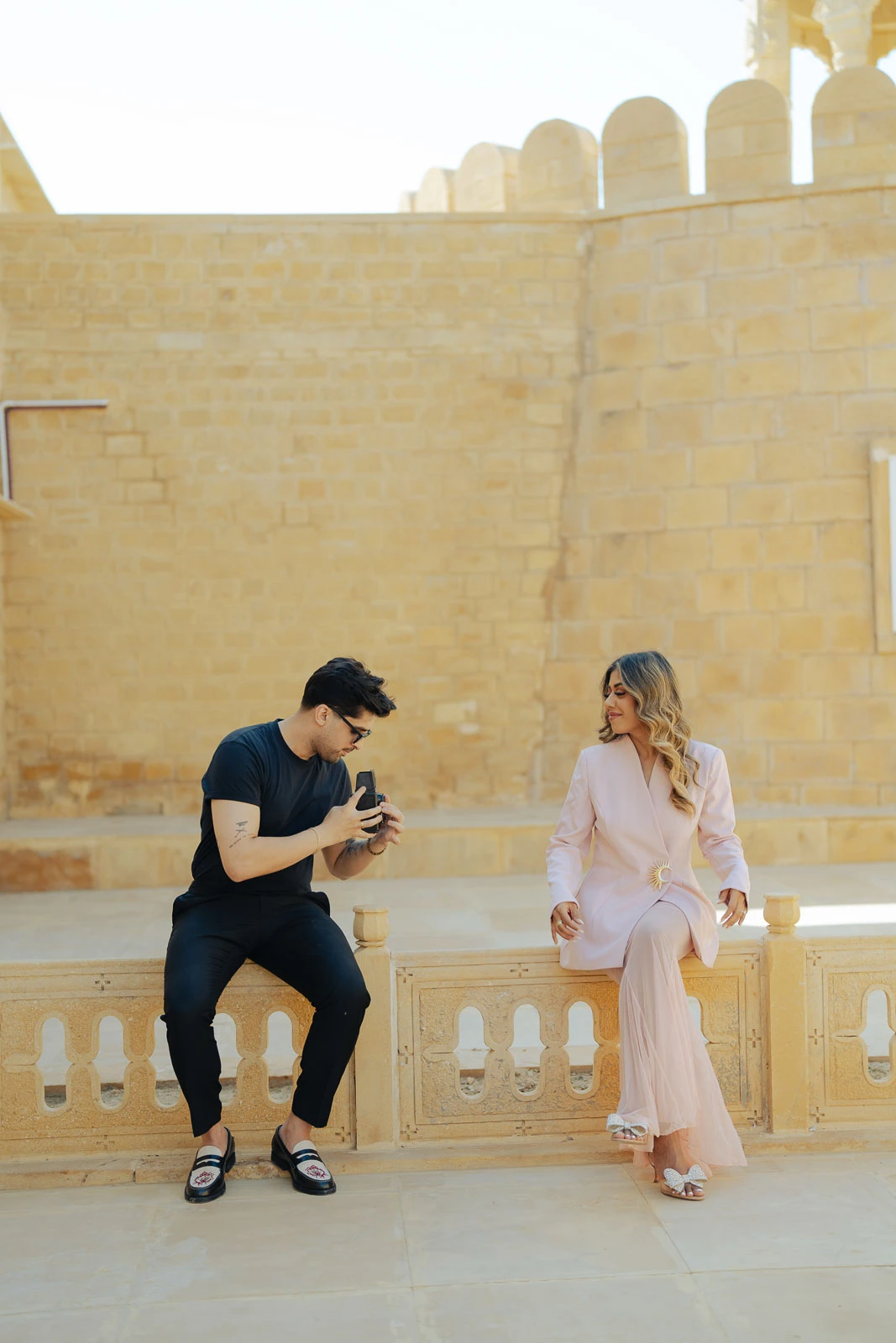 Playful Couple Moment Against Jaisalmer Architecture
