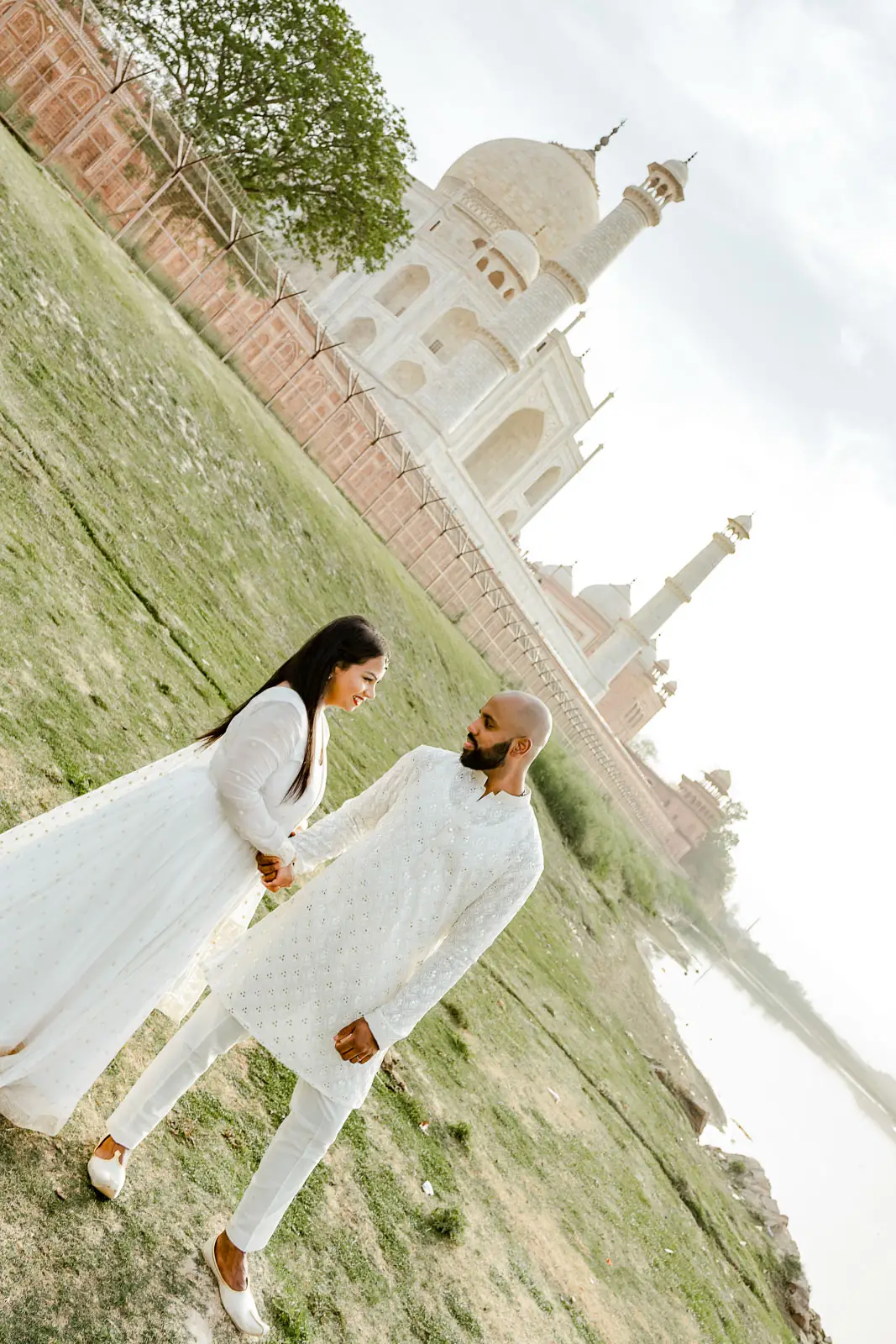 Romantic Couple Strolling Through Taj Mahal Gardens