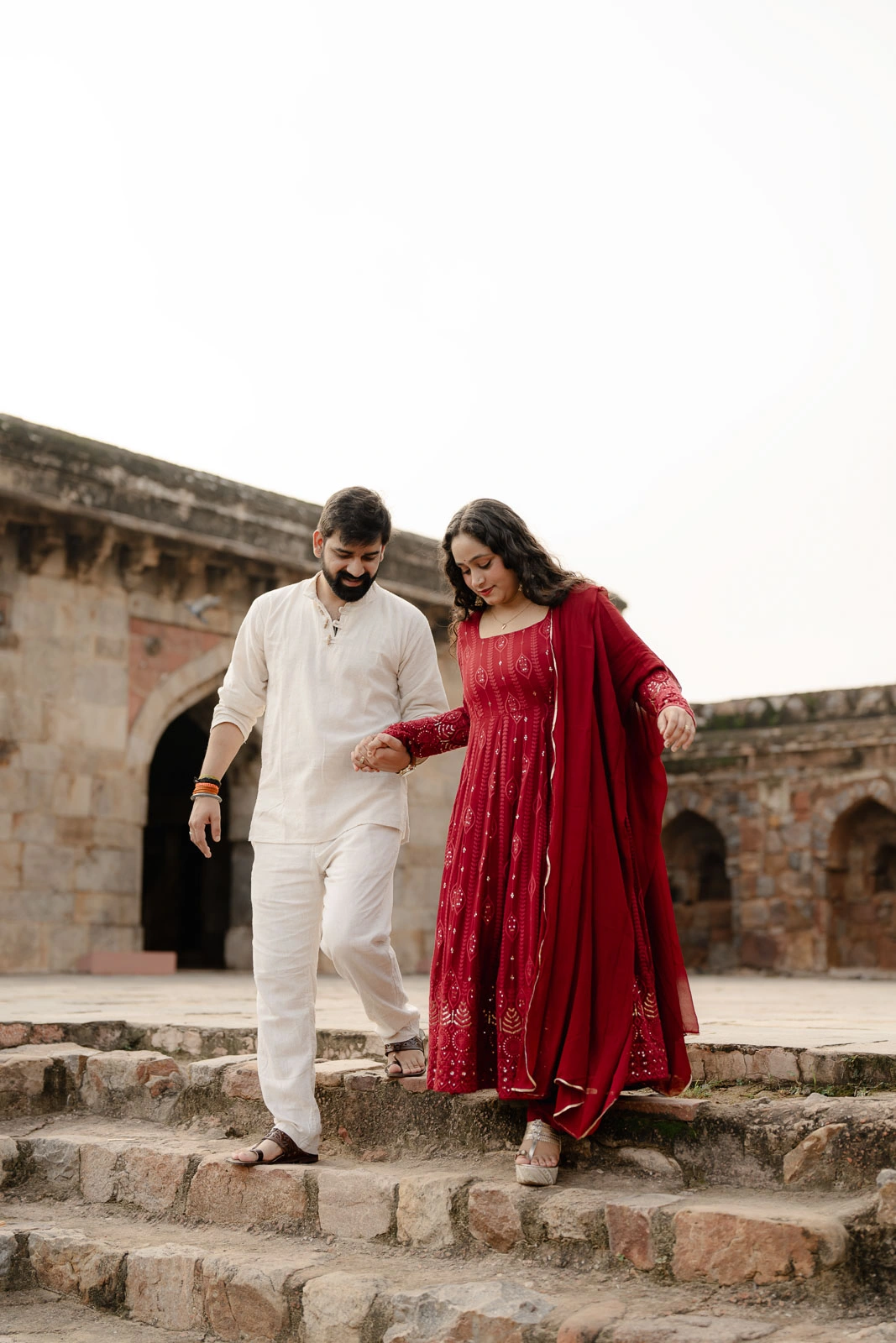 Romantic Couple Walking Through a Historic Delhi Courtyard