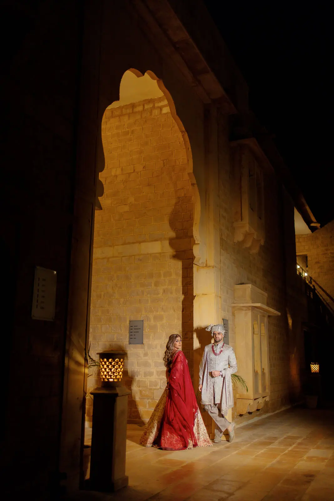 The Couple Beneath the Ancient Palace Arch