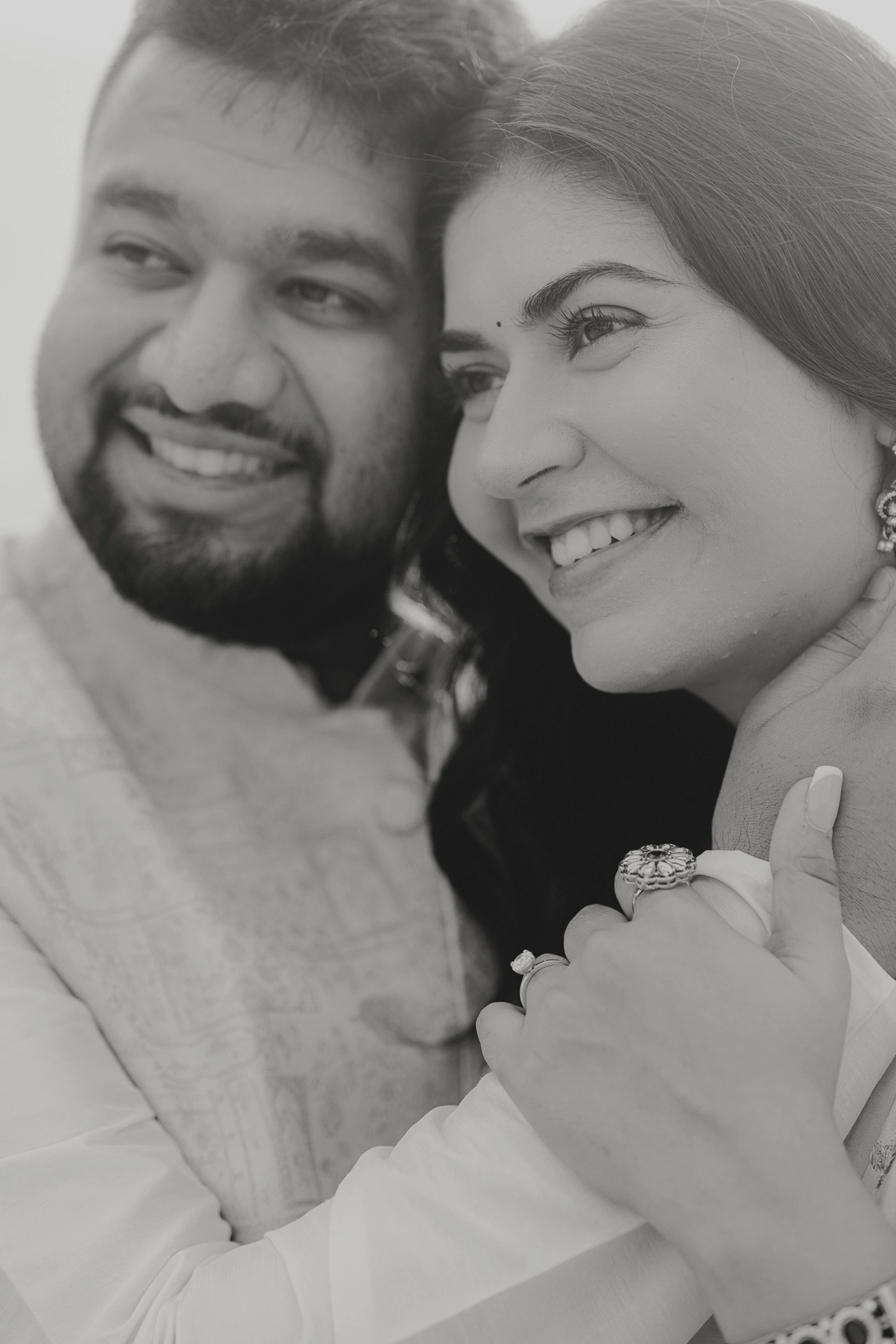 Black and white close-up portrait of smiling couple