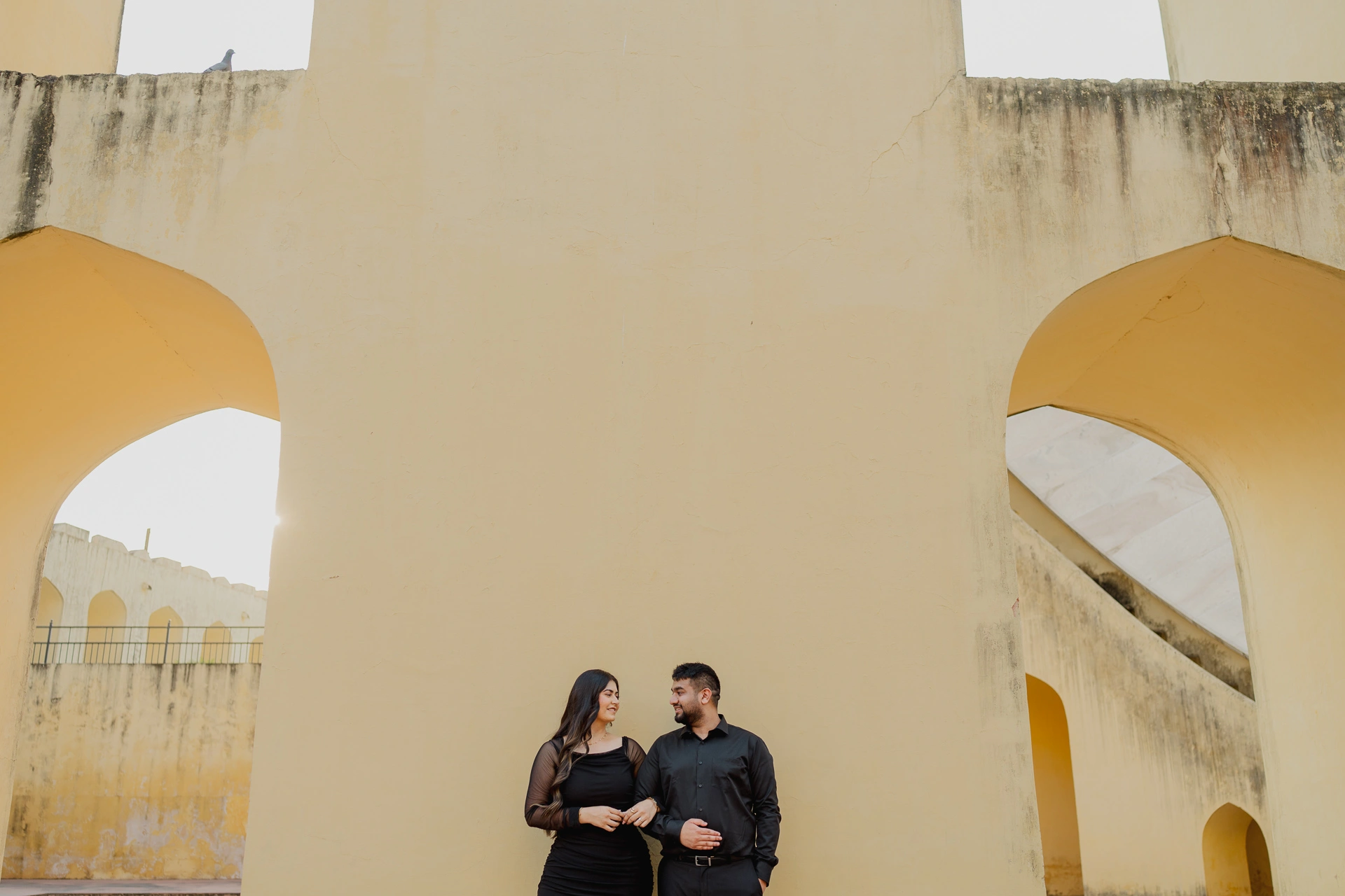 Black and white photo of couple near stone instruments
