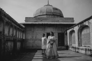 Black and white wide shot of couple in a fort courtyard