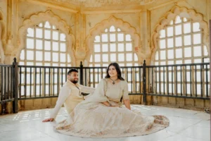 Bride seated alone beneath ornate fort windows