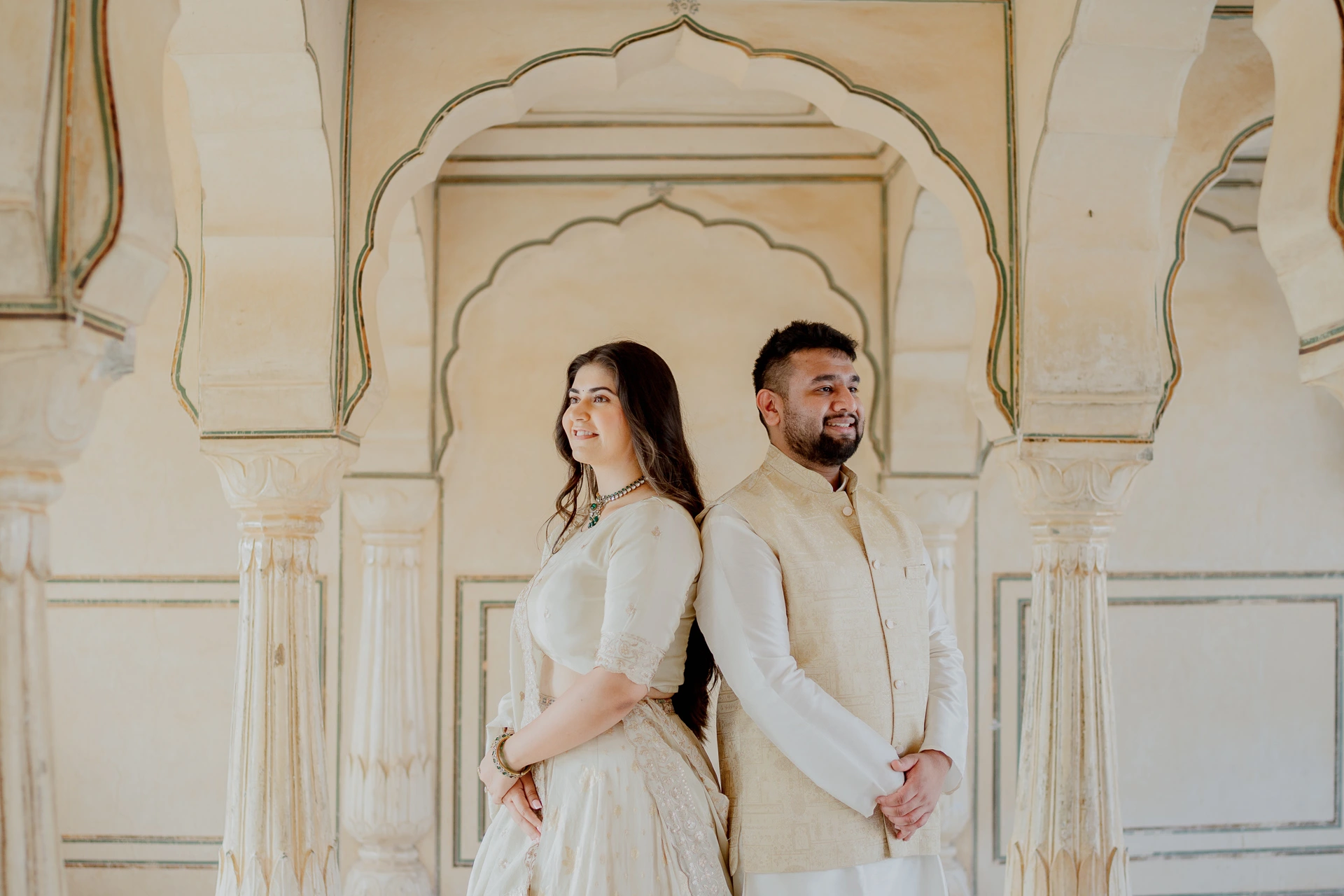 Bride standing alone in a fort courtyard, Amer Fort