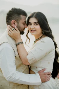 Close portrait of couple in white attire, foreheads togethe
