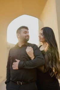Close-up of couple embracing in black outfits