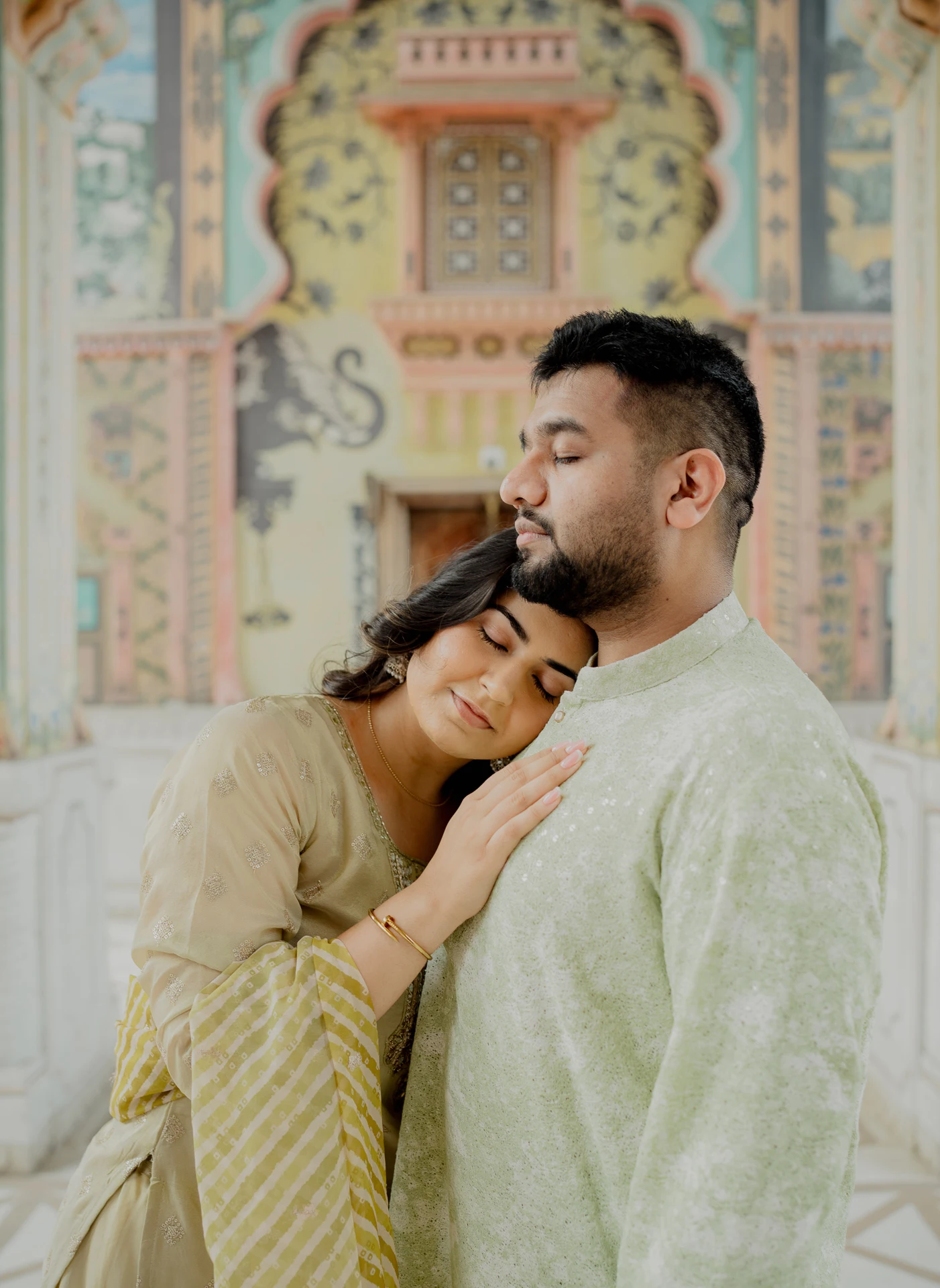 Close-up of couple embracing near a mosaic wall, Jaipur pre-wedding shoot