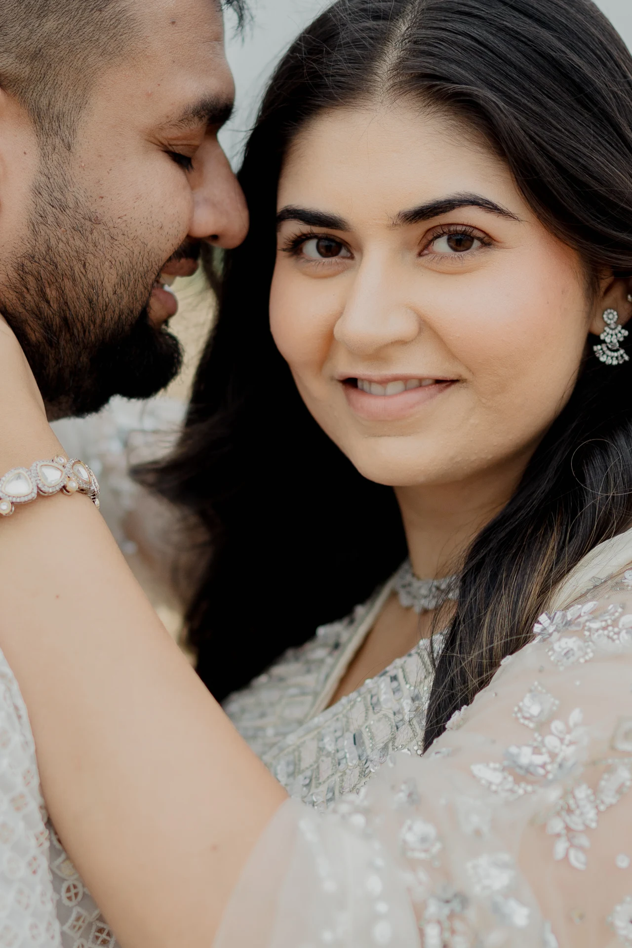 Close-up portrait of couple in white outfits
