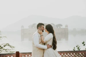 Couple embracing with a lake and hills behind them