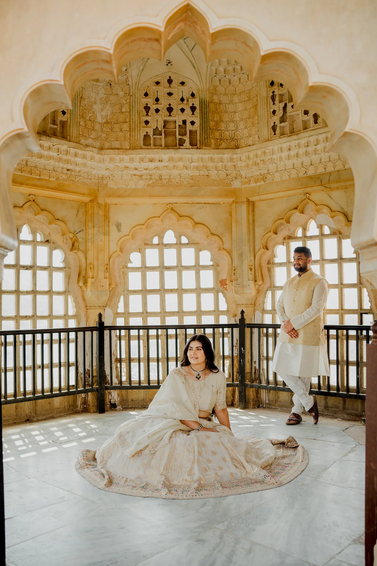 Couple seated together in a latticed fort window