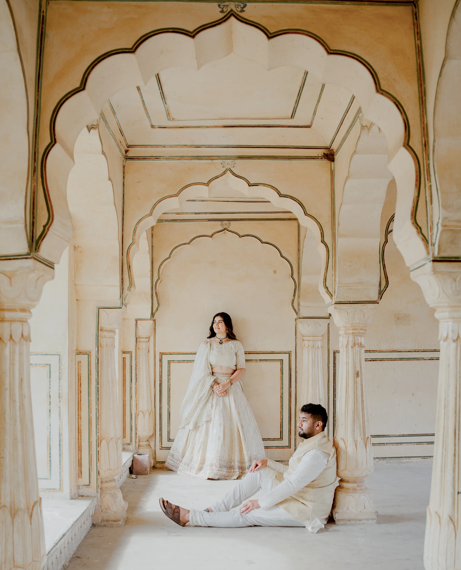 Couple seated within an arched fort corridor, Amer Fort
