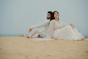 Couple sitting close together on sand