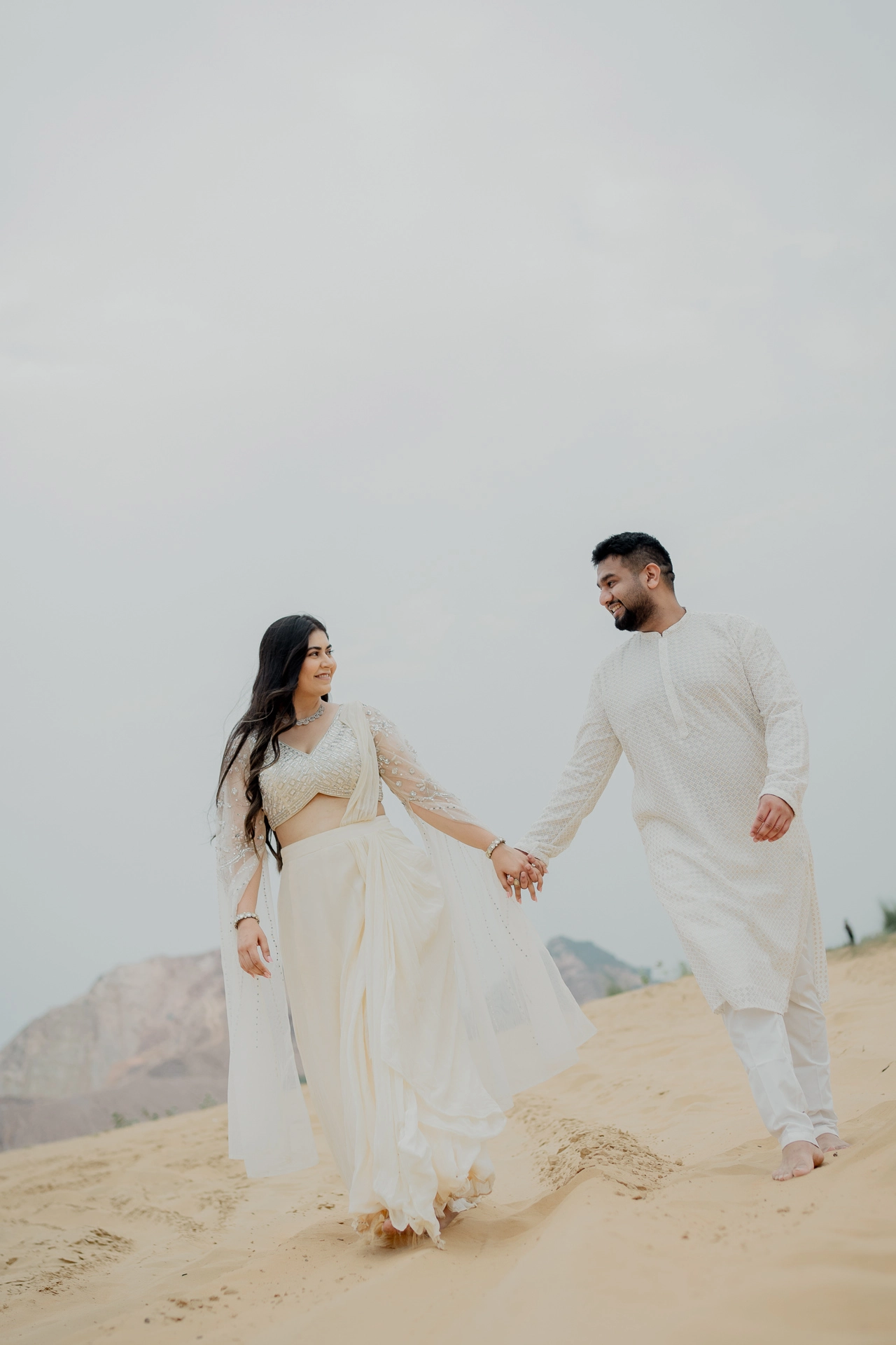 Couple sitting on sand together, Jaipur pre-wedding shoot