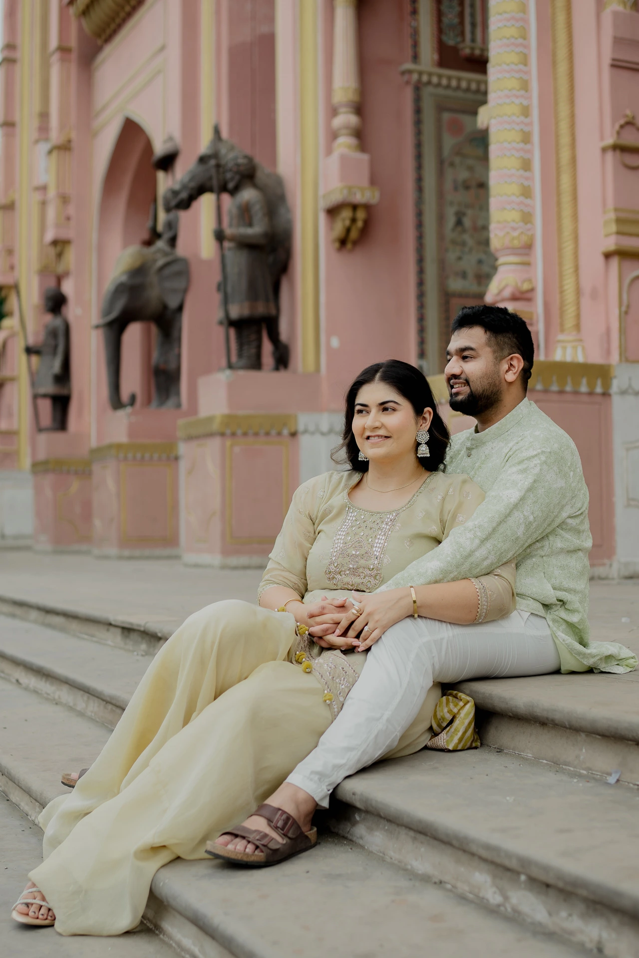 Couple sitting on steps in traditional attire, Jaipur pre-wedding shoot