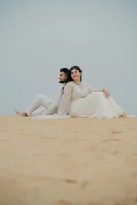 Couple sitting together on a sand dune