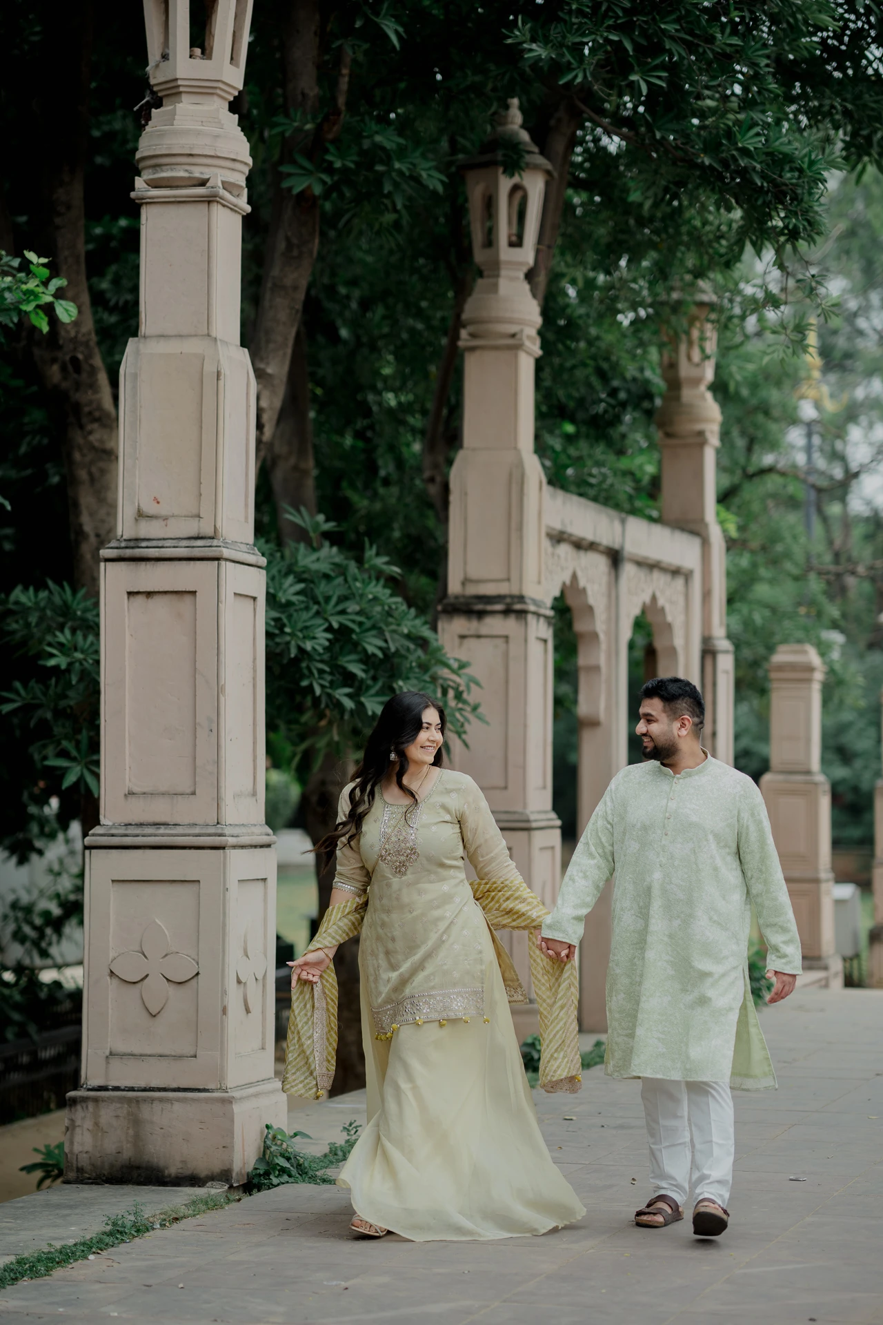 Couple standing at a colorful mosaic gateway