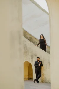 Couple standing beside a tall stone stairway