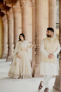 Couple standing between sandstone pillars, Amer Fort