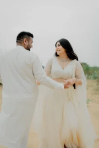 Couple standing face to face in white attire