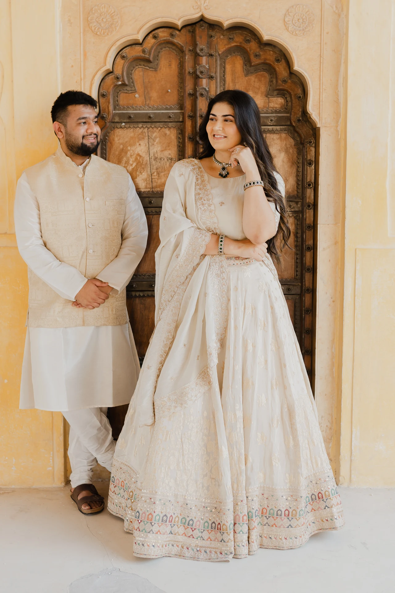 Couple standing in a carved doorway, Amer Fort