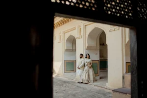Couple standing in a dark archway with fairy lights, Amer Fort