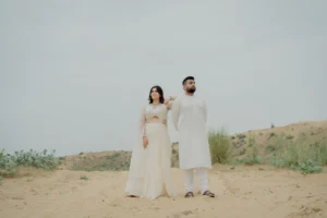 Couple standing in a sandy landscape