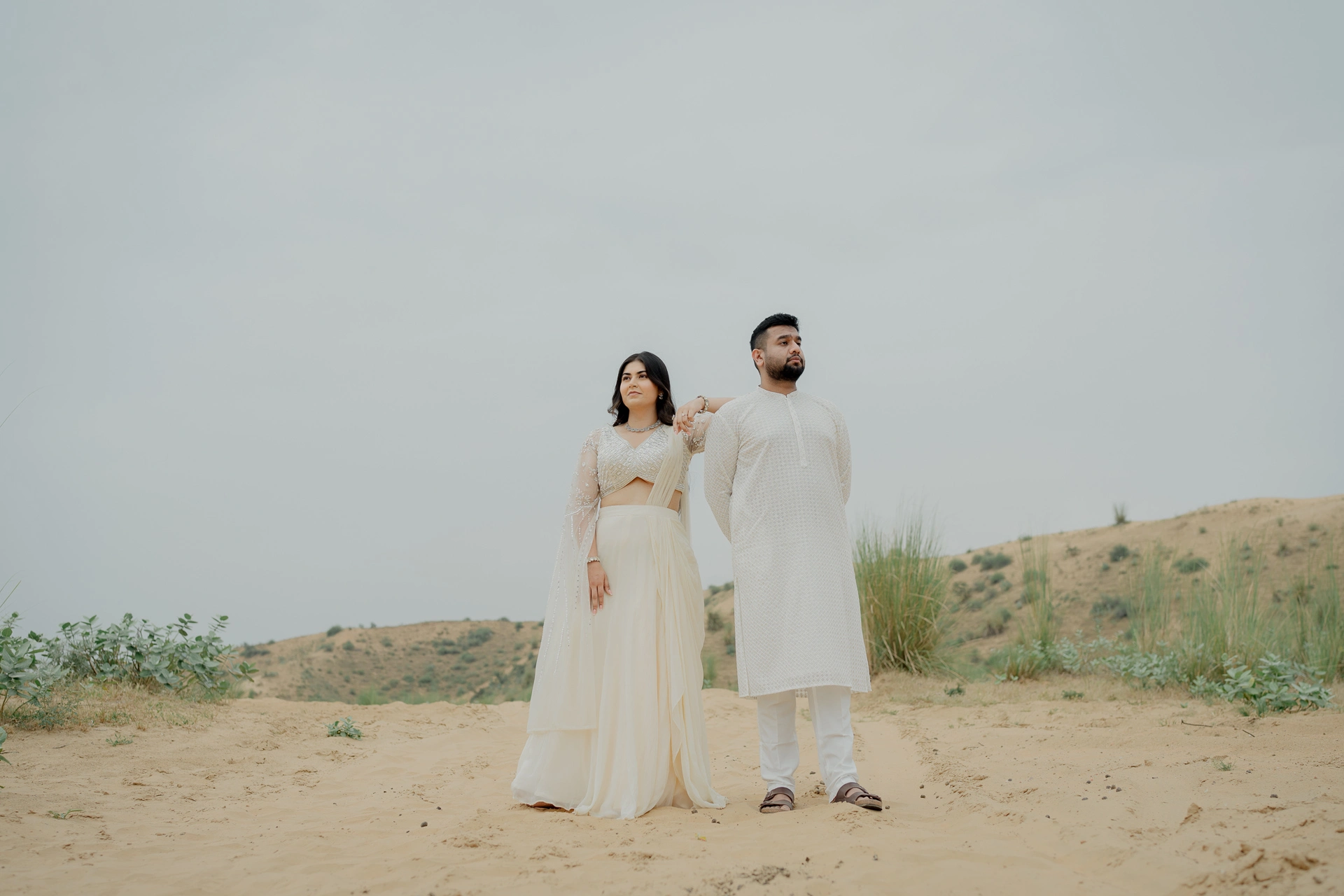 Couple standing in a sandy landscape