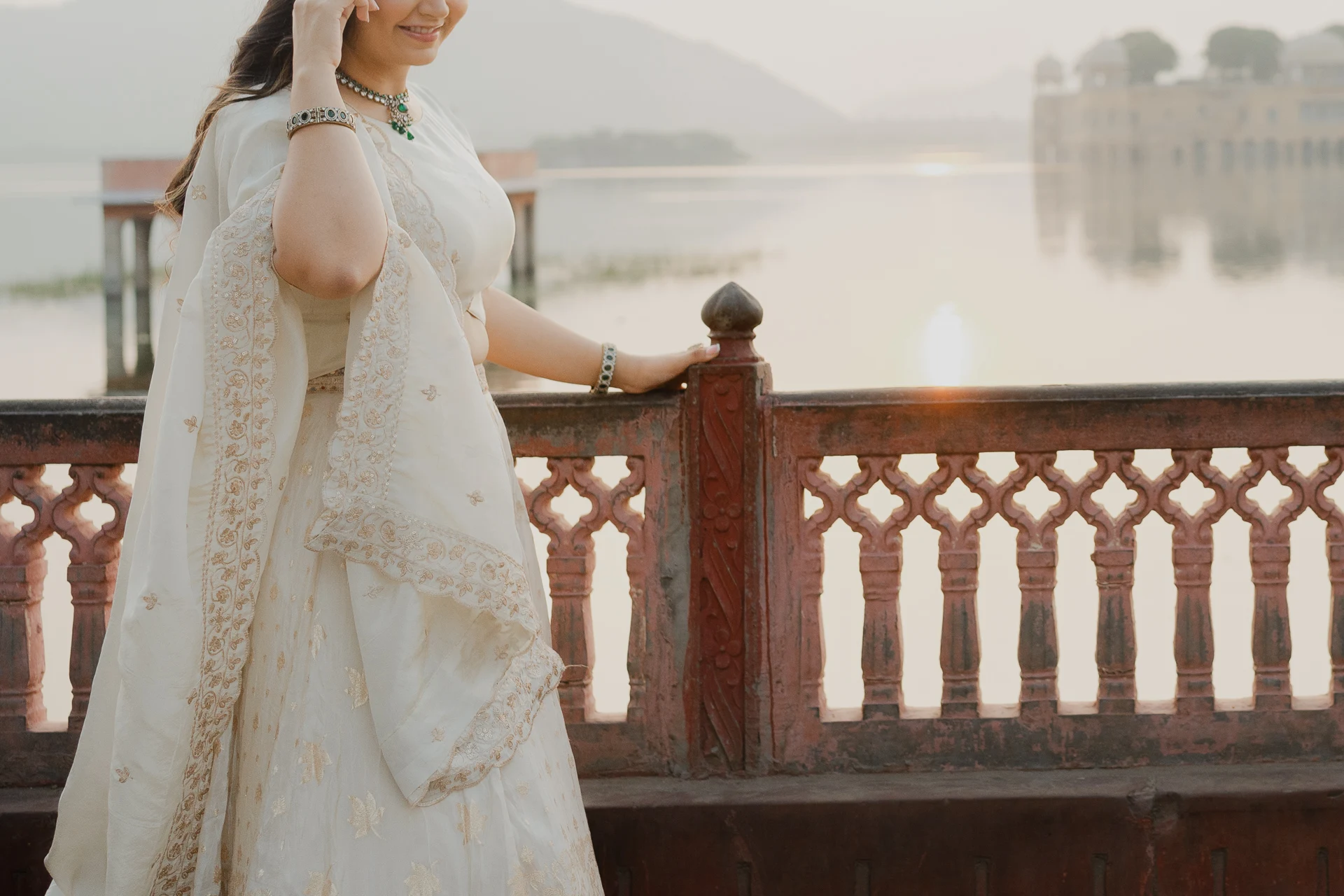 Couple standing near a red railing terrace, Jaipur pre-wedding shoot