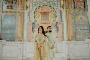 Couple standing near colorful mosaic archway, Jaipur