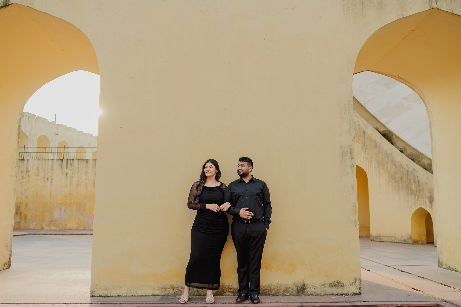 Couple standing near instruments at Jantar Mantar, Jaipur