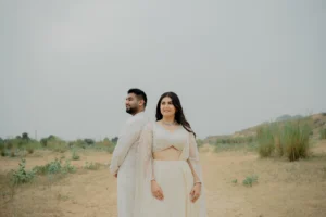Couple standing side by side in an open landscape