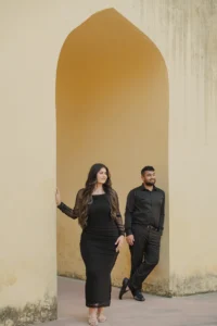 Couple standing together in a shaded stone alcove