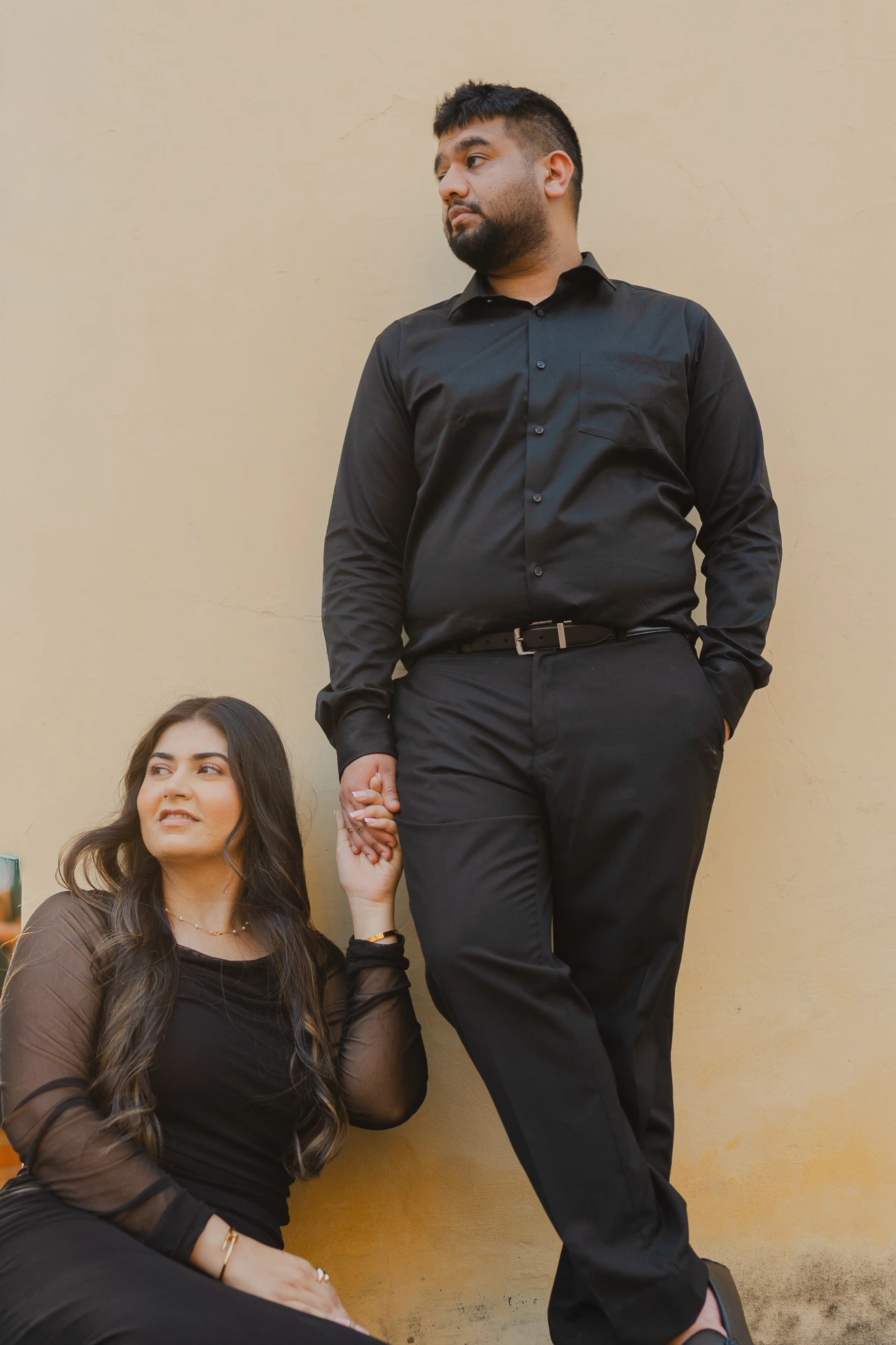 Couple standing together in an arched stone corridor