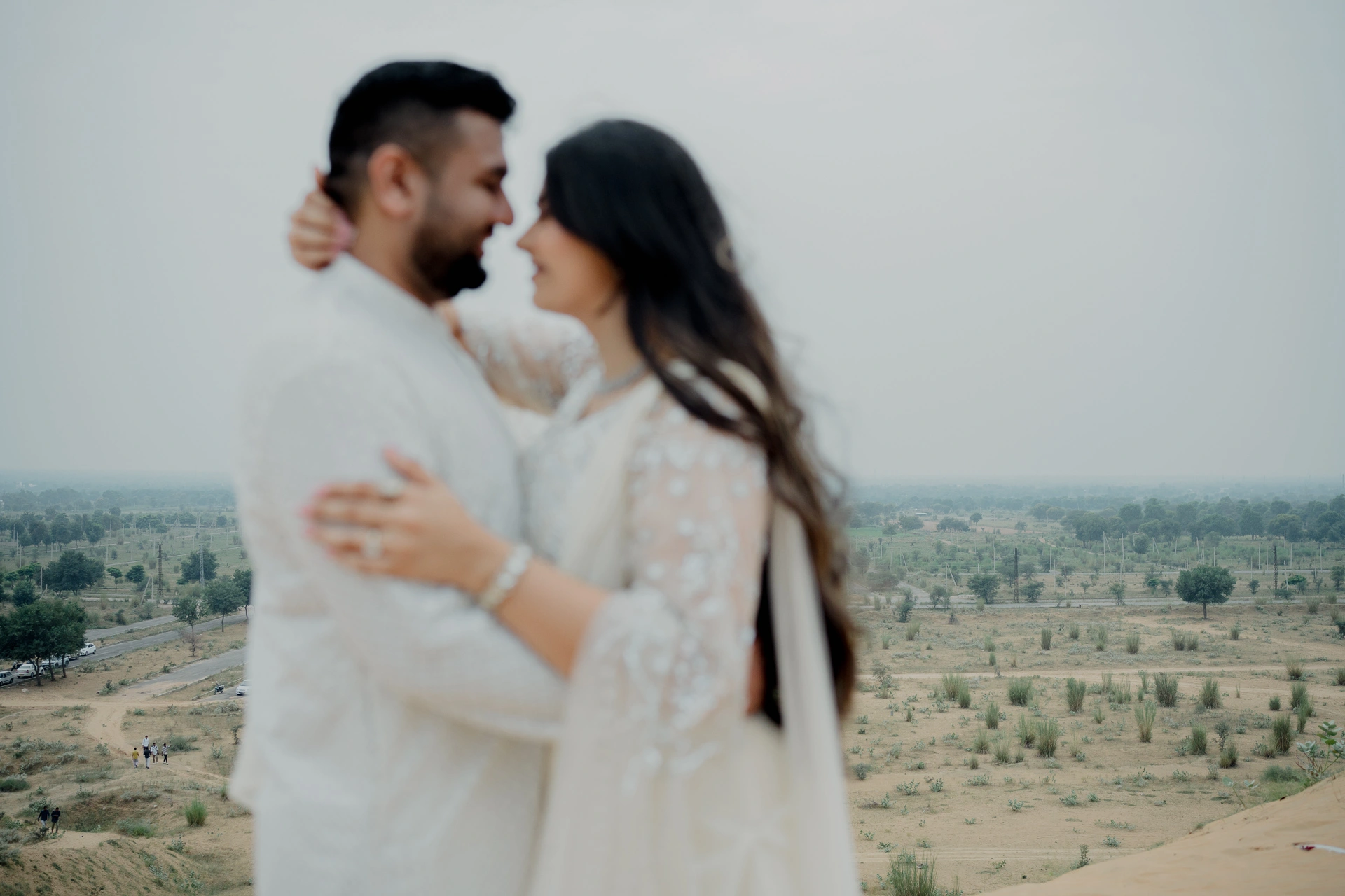 Couple standing together in an open field, Jaipur pre-wedding shoot