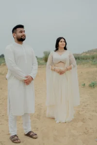 Couple standing together in white outfits outdoors, Jaipur