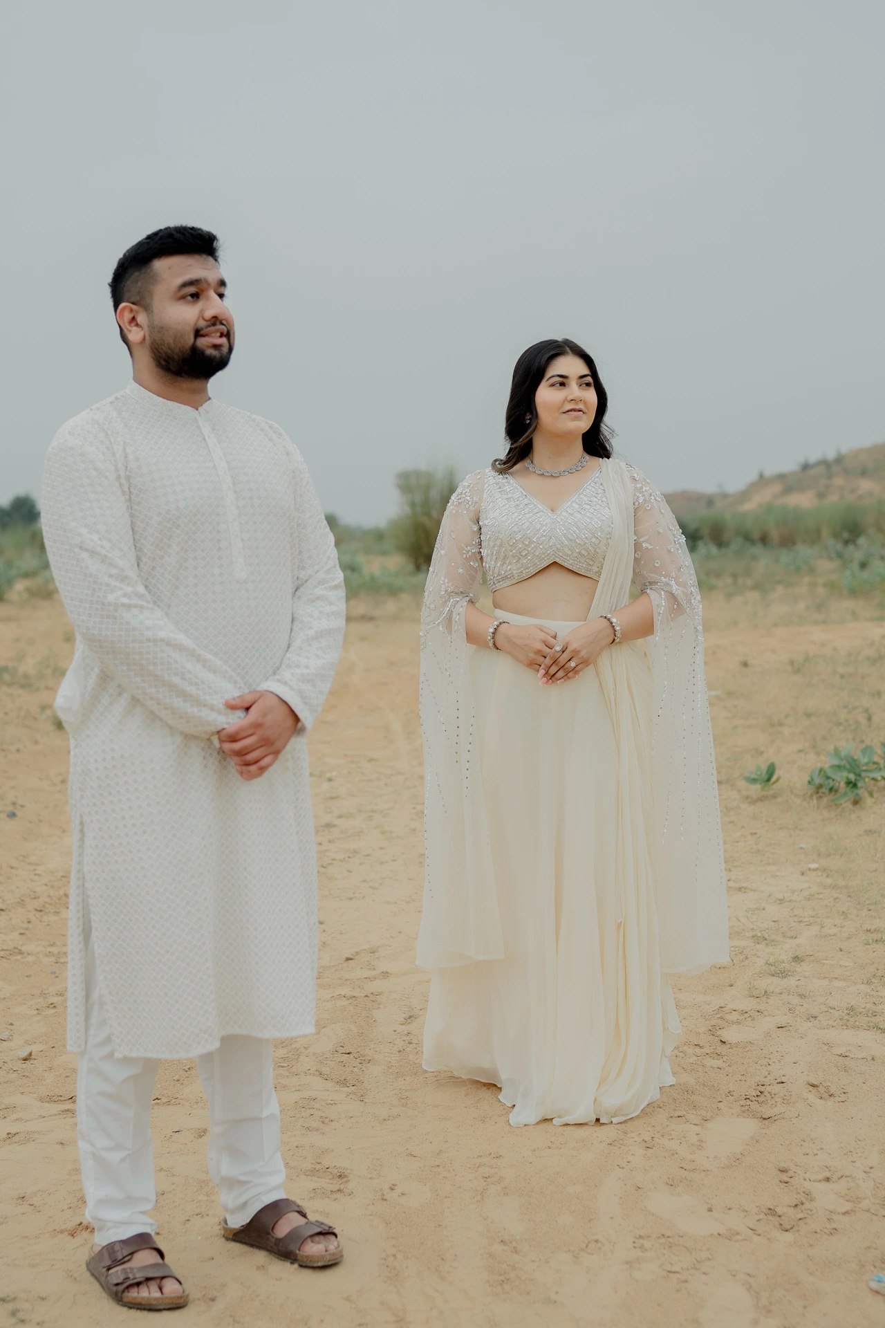 Couple standing together in white outfits outdoors, Jaipur