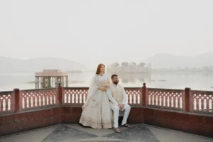Couple standing together on a terrace with lake view, Jaipur
