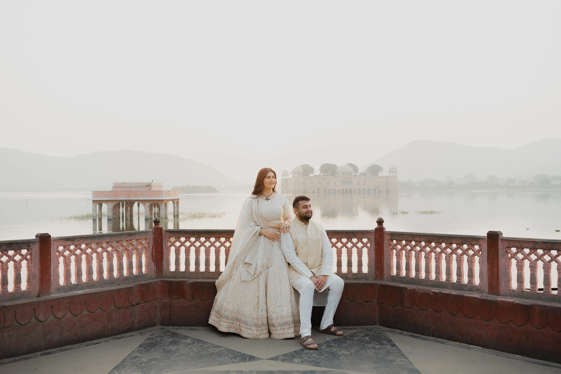Couple standing together on a terrace with lake view, Jaipur