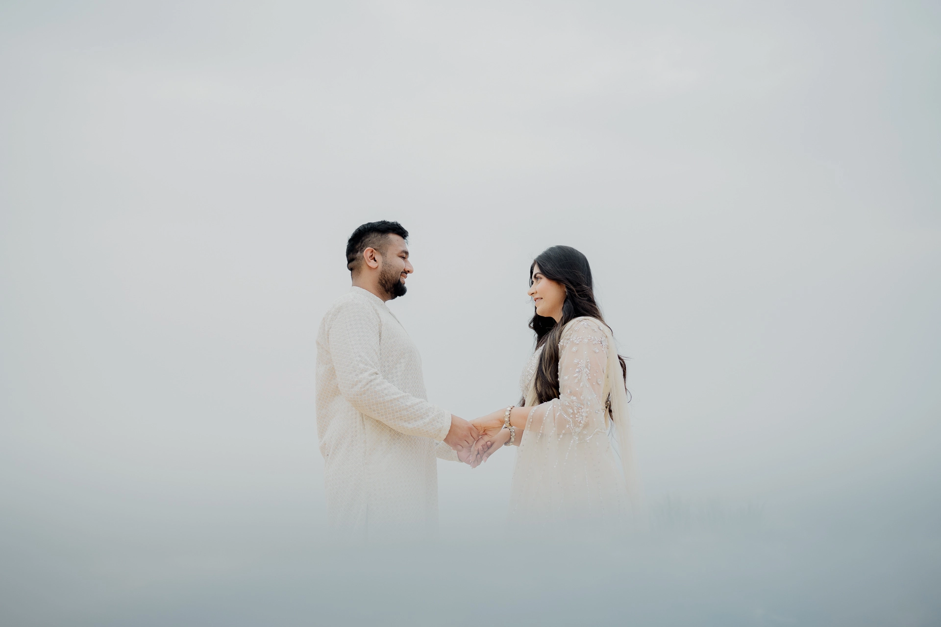 Couple standing together on open ground