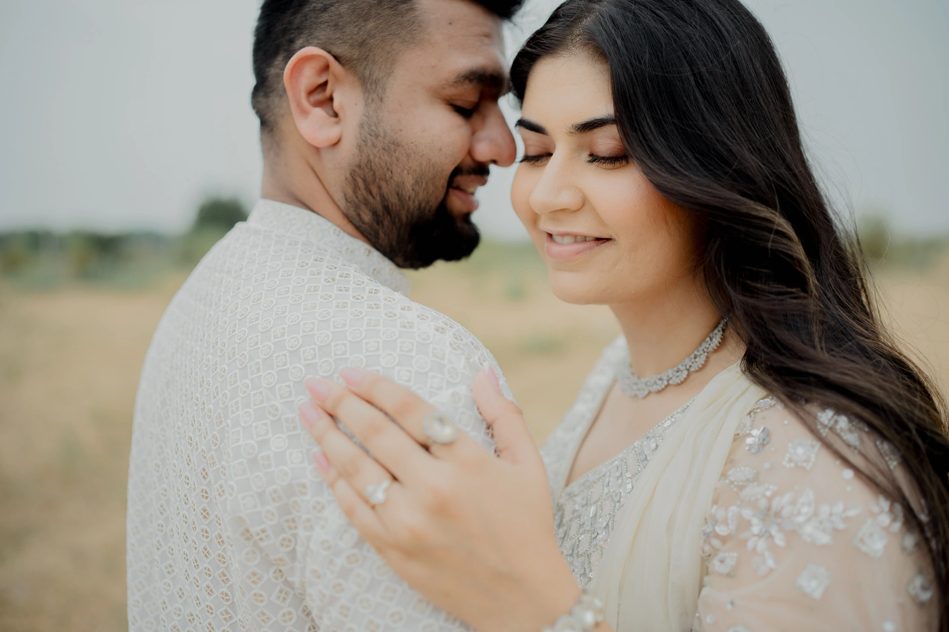 Couple standing together outdoors in white attire, Jaipur