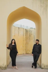 Couple standing under a mustard-colored archway